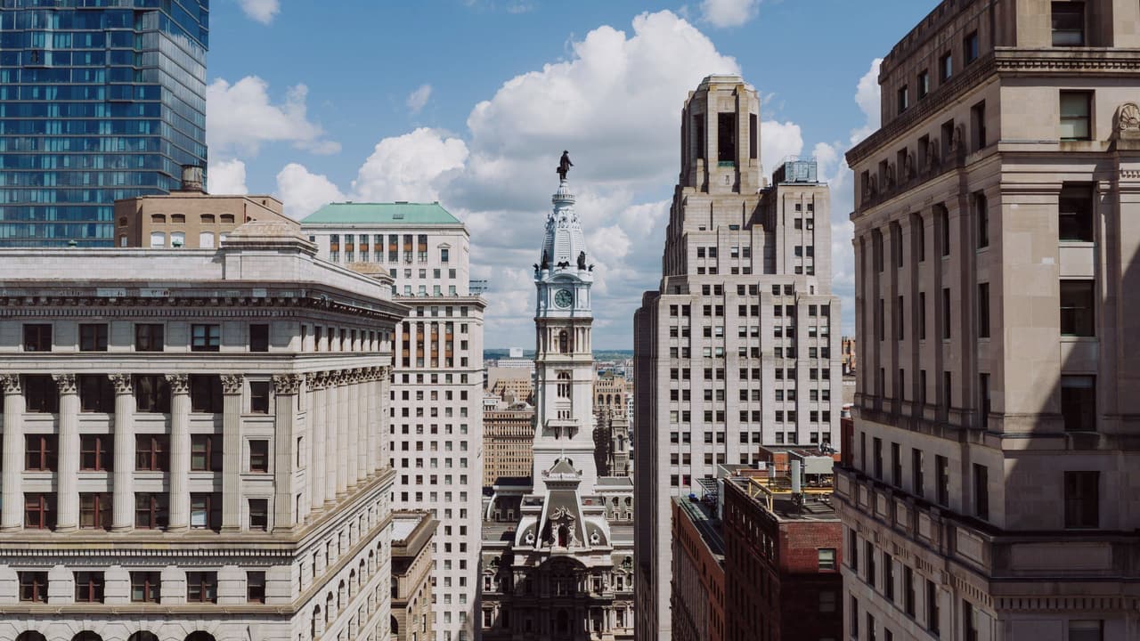 Philadelphia City Hall tower framed by downtown buildings